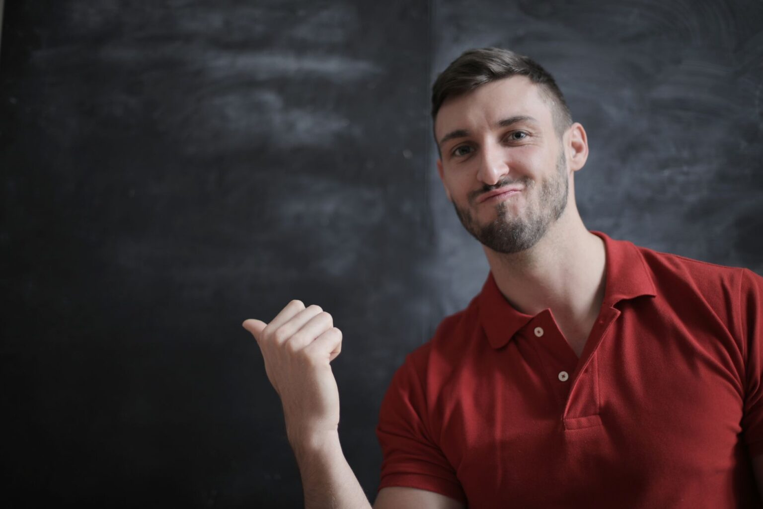 Caleb in front of the chalkboard, explaining a point